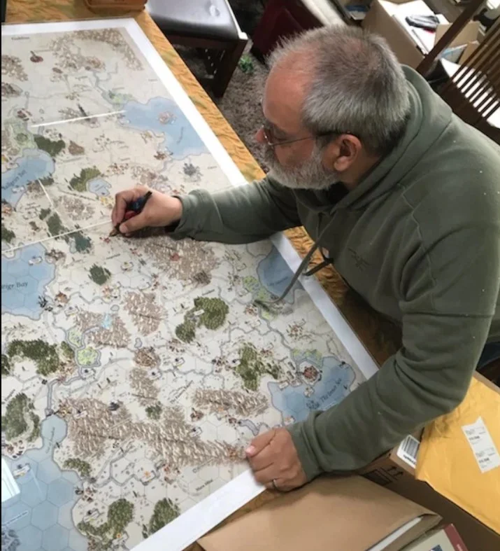 Christopher Moeller at the drawing table, inking the hand-drawn maps of Kalar for Burning Banners